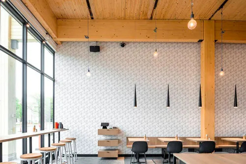 Bright modern school commons with wood ceiling slats