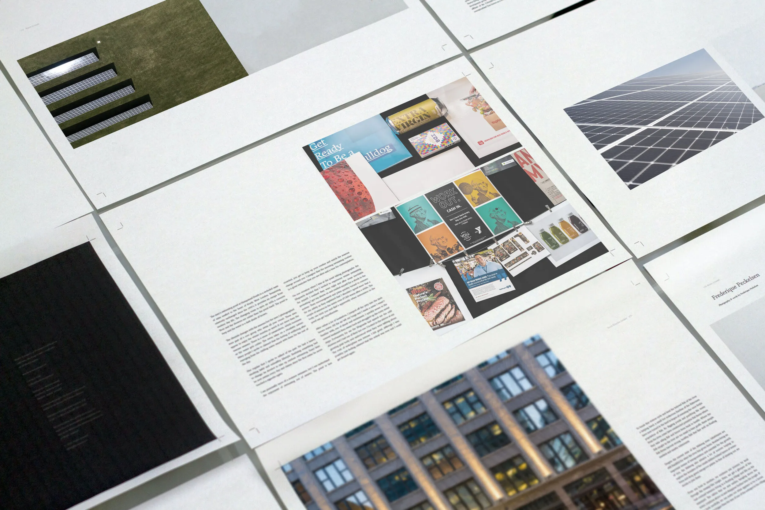 Printed marketing collateral and proposal layouts fanned across a table