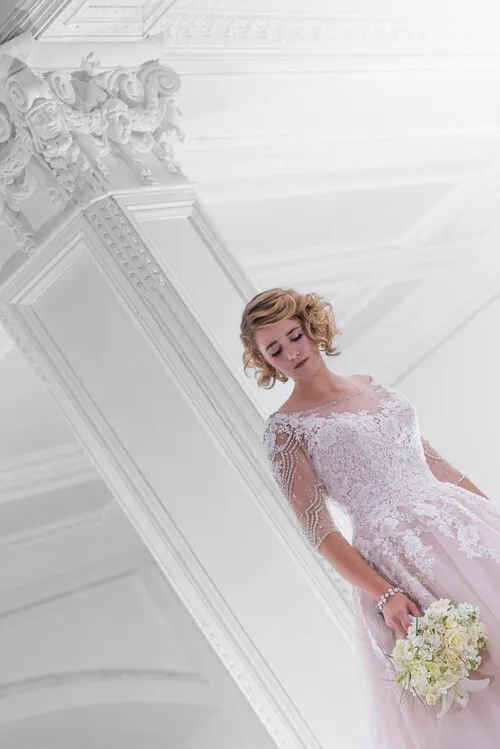 Bride posing on a white staircase